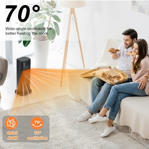 Couple eating pizza on a couch with a space heater in the room